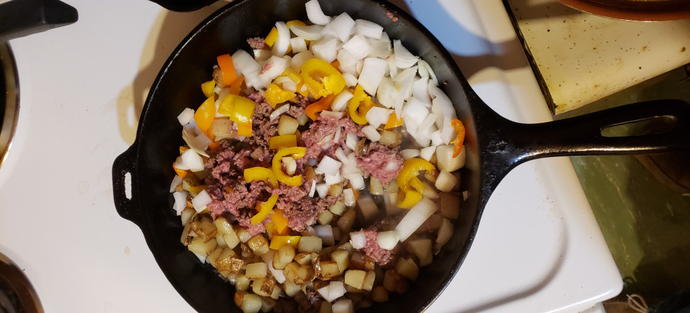 Ground beef, potatoes and vegetables cooking